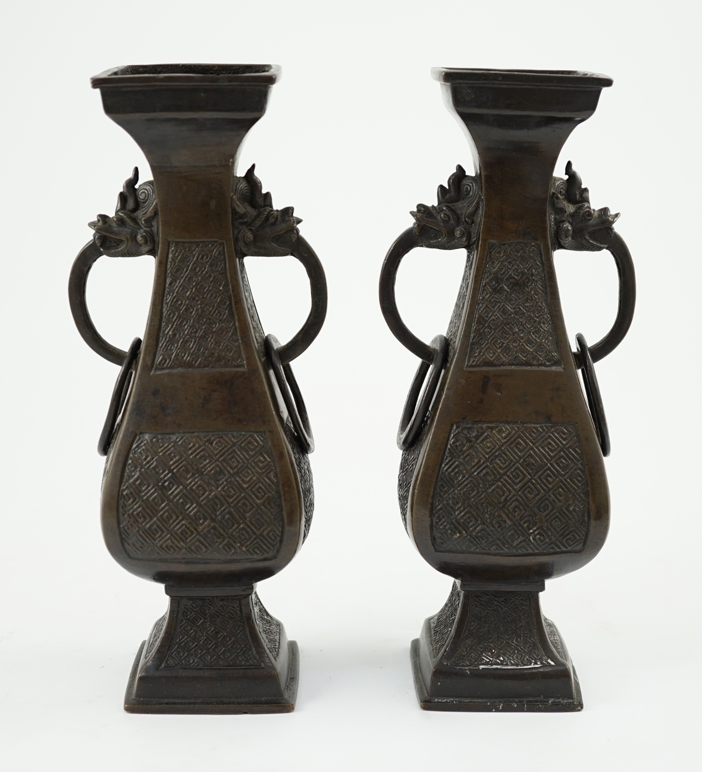 A pair of Chinese archaistic bronze two handled altar vases, Ming dynasty, 23cm high